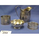 Bag of silver items to include: silver cream jug, Chester hallmarks; two silver napkin rings,