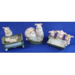 Set of three German porcelain pig figure groups with sparsely coloured decoration,