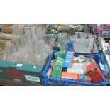 Three trays of assorted glass oil burner chimneys, some in boxes,