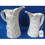 Royal Worcester ivory coloured porcelain leaf jug together with another similar, smaller.