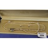 Cased pearls to include two necklaces and two sets of earrings in Lotus box.