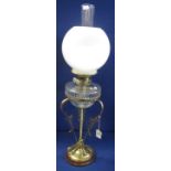 Early 20th Century double burner oil lamp with cut glass reservoir on a triform,