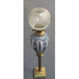 Early 20th Century double burner oil lamp with blue and white printed foliate design reservoir on a
