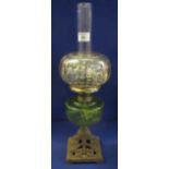 Early 20th Century single burner oil lamp with wrythen green glass reservoir and cast metal,