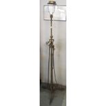 Wrought iron telescopic standard lamp on triform base.