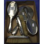 Box containing assorted silver vanity items to include four brushes and mirror.