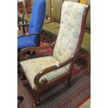 20th Century mahogany open arm upholstered rocking chair.