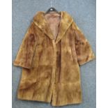 A three-quarter length vintage light brown fur coat, probably rabbit fur. No label.