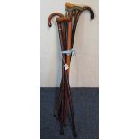 Group of assorted walking sticks, brass handles etc.