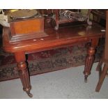Victorian mahogany extending dining table on fluted legs, metal cups and casters.