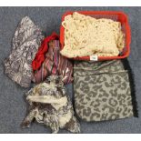 Box full of scarves, together with a crocheted throw. Scarves are of various patterns and fabrics.