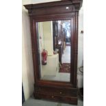 Victorian mahogany mirror door wardrobe with barley twist moulded and foliate decoration.