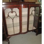 Early 20th Century mahogany display cabinet on cabriole legs and ball and claw feet.