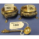 Pair of silver, circular, repousse salts, raised on three hoof design feet, London, 1866,