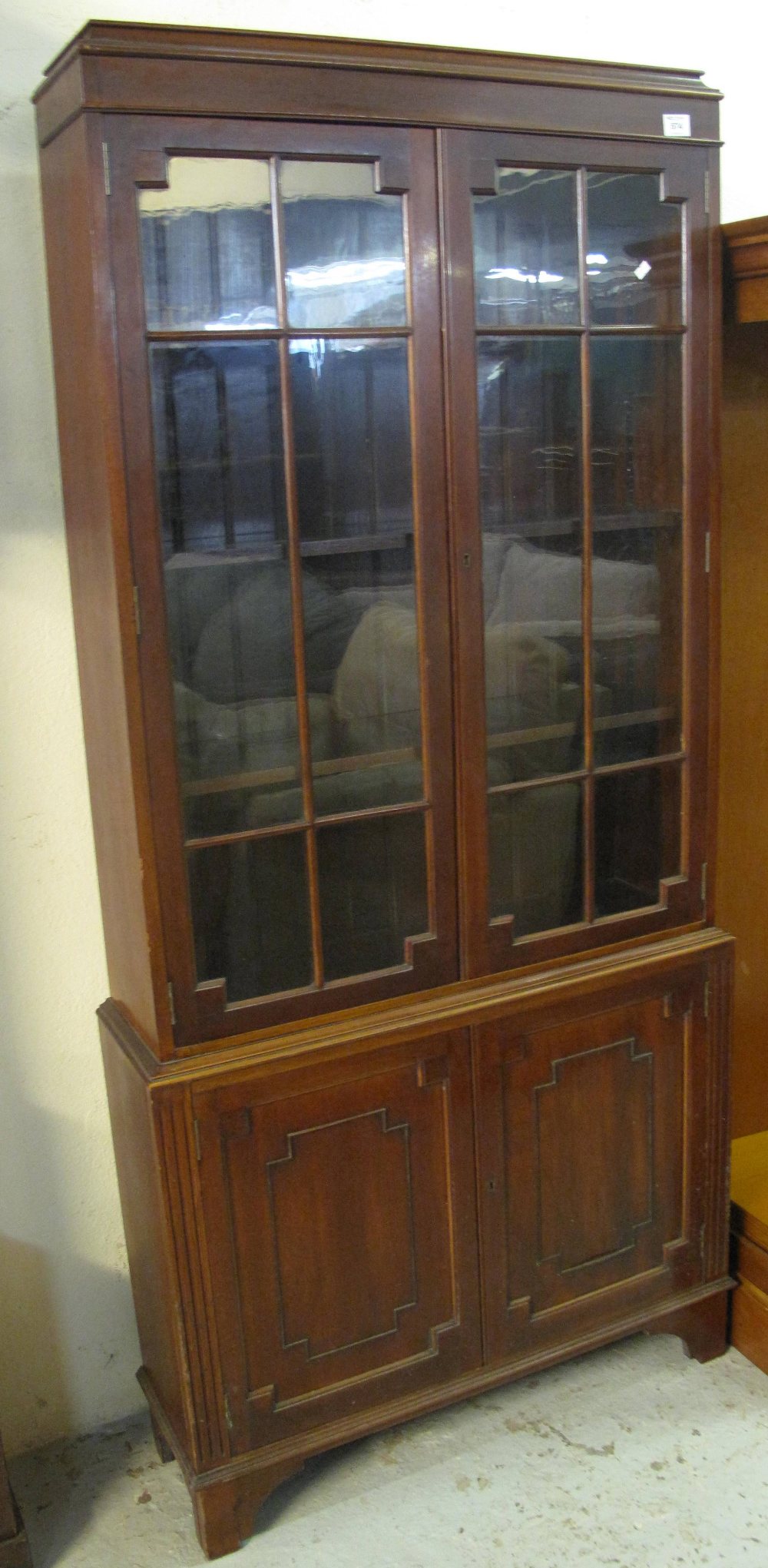 Early 20th Century mahogany glazed bookcase on bracket feet.
