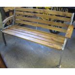 Wooden garden bench with painted cast iron supports.