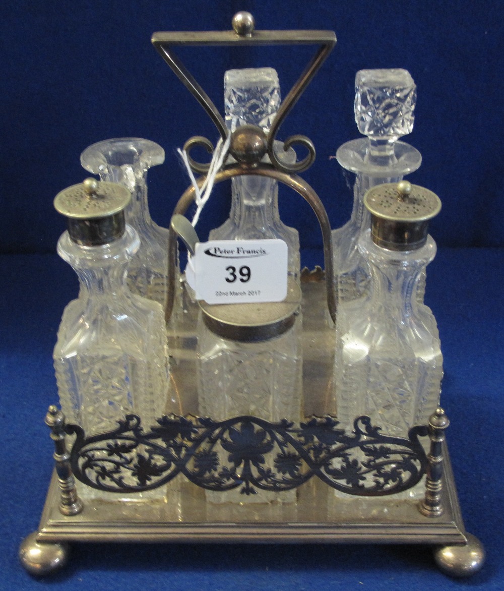 Early 20th Century silver plated six bottle cruet stand containing assorted cut glass condiments.