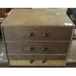 Small oak three drawer table top cabinet.