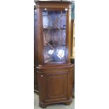 Reproduction mahogany astragal glazed corner cabinet.