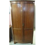 Early 20th Century mahogany bow front, two door wardrobe.