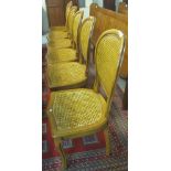 Set of six modern hardwood dining chairs with cane backs and seats, on cabriole legs.