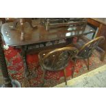 Mid 20th Century elm refectory table together with a set of four wheel back chairs.