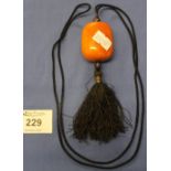 Large amber coloured bead necklace with drop tassel.