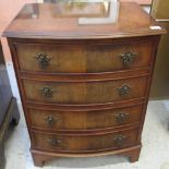 Reproduction walnut bow front narrow chest of four long drawers on bracket feet.