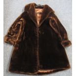 Three-Quarter length vintage dark brown mouton fur coat, label reads: 'Real Pannofix from Hungary'.