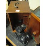 Mid 20th Century black enamelled binocular microscope in original mahogany box.