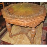 Carved oak octagonal table on 'X' stretcher support and carved, foliate baluster legs.