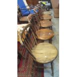 Set of five 20th Century elm spindle back kitchen chairs with circular seats.