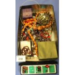 Tin of assorted costume jewellery to include: multi-stone bangles; amber coloured graduated beads;