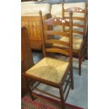 Pair of 20th Century oak, ladder back kitchen chairs with rush seats.