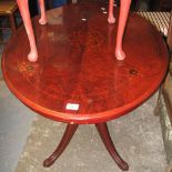 Reproduction walnut stained and inlaid loo table on quatraform base.