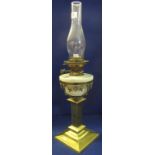 Brass double burner oil lamp with ceramic reservoir on glass pedestal base with clear chimney. (B.P.