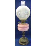 Late 19th Century brass double burner oil lamp with repousse pink glass reservoir on pierced metal