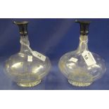 Pair of Victorian star and slice cut baluster shaped decanters with silver mounts, London hallmarks.