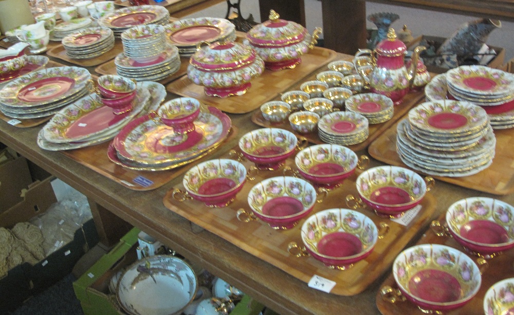 Nine trays of 'Bavaria' tea and dinnerware items on a gilt and burgundy ground with figures,