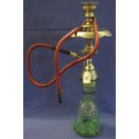 Metal mounted hubble-bubble type pipe with glass reservoir and flexible tube. (B.P. 24% incl.