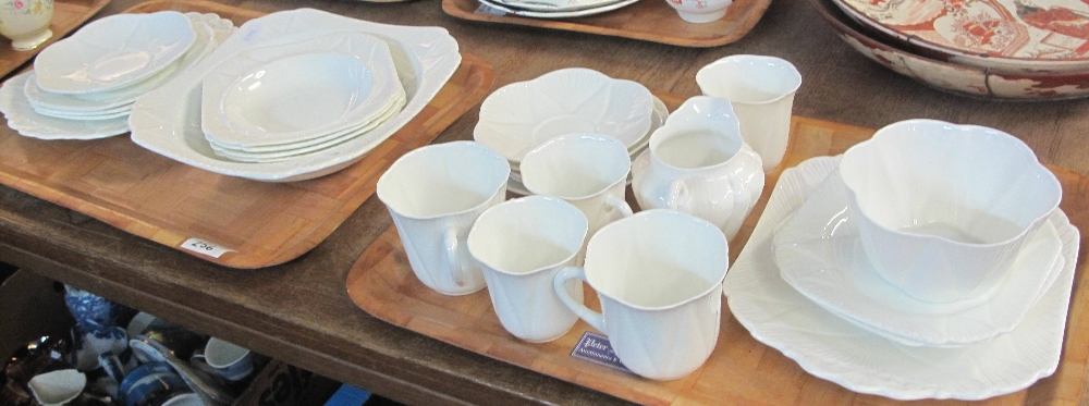 Two trays of white Shelley fluted teaware items comprising: teacups and saucers; milk jug;