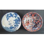 TWO JAPANESE PORCELAIN PLAQUES OR SHALLOW DISHES, one decorated with figures amongst foliage