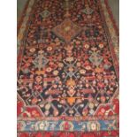 PERSIAN HAMADAN LORI CARPET overall decorated with flower heads and geometric designs on a dark blue