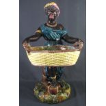 LARGE STAFFORDSHIRE MAJOLICA FIGURE OF A STANDING BLACK WOMAN with basket,