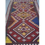 MIDDLE EASTERN FLAT WEAVE, GEOMETRIC, RED GROUND QUASHGAI KELIM, 290 x 135cm. (B.P. 24% incl. VAT)