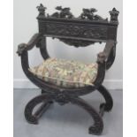 VICTORIAN CARVED AND STAINED SAVONAROLA TYPE ELBOW CHAIR, overall decorated with foliate scrolls,