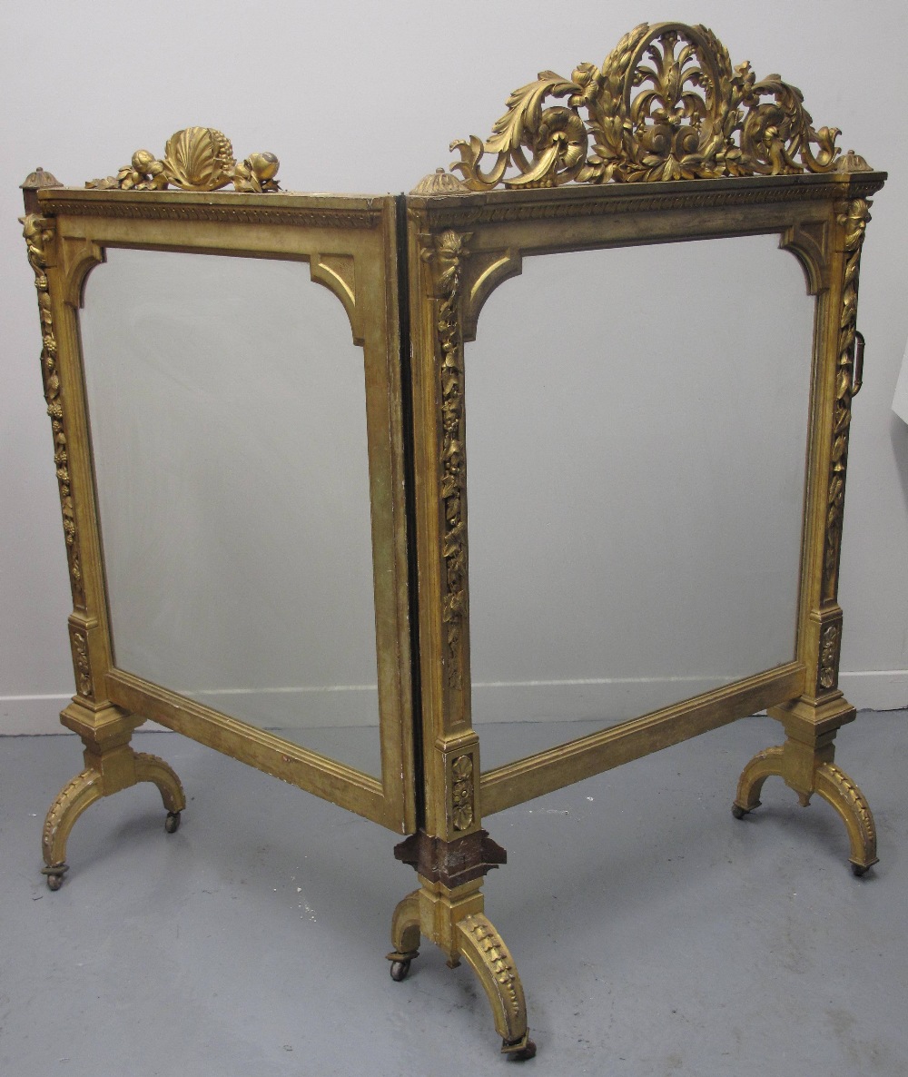 EARLY VICTORIAN HINGED, TWO SECTION, GILDED AND GESSO CARVED WOODEN FIRE SCREEN, with foliate