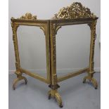 EARLY VICTORIAN HINGED, TWO SECTION, GILDED AND GESSO CARVED WOODEN FIRE SCREEN, with foliate