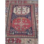 CAUCASIAN AKSTAKA RUG OF GEOMETRIC FORM with stylised Tree of Life and latch hook decoration. 136