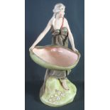 ROYAL DUX PORCELAIN STANDING FIGURE OF A LADY IN CLASSICAL ROBE HOLDING A SHELL SHAPED DISH,